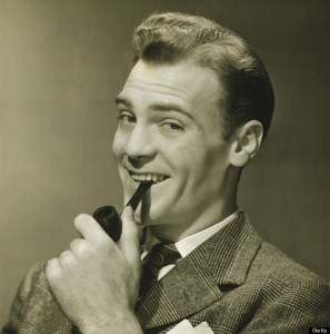 Businessman holding pipe in mouth, smiling, (B&W), portrait